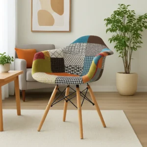 Patchwork Accent Chair with multicoloured patterned upholstery, cushioned seat, curved wraparound backrest with integrated arm sections, four angled wood-toned legs and dark cross-bracing