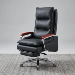 Executive Recliner Office Chair with Footrest featuring a high-back black leatherette frame, overstuffed segmented cushioning, curved chrome armrests with mahogany wood caps, an integrated retractable leg rest, and a polished chrome wheeled base.