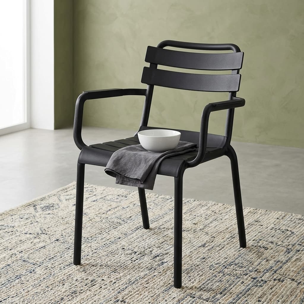 Stackable Plastic Dining Armchair Showcasing A Molded Black Polypropylene Frame, A Curved Slatted Backrest And Seat Pan With Horizontal Planks, And Integrated Loop Armrests.
