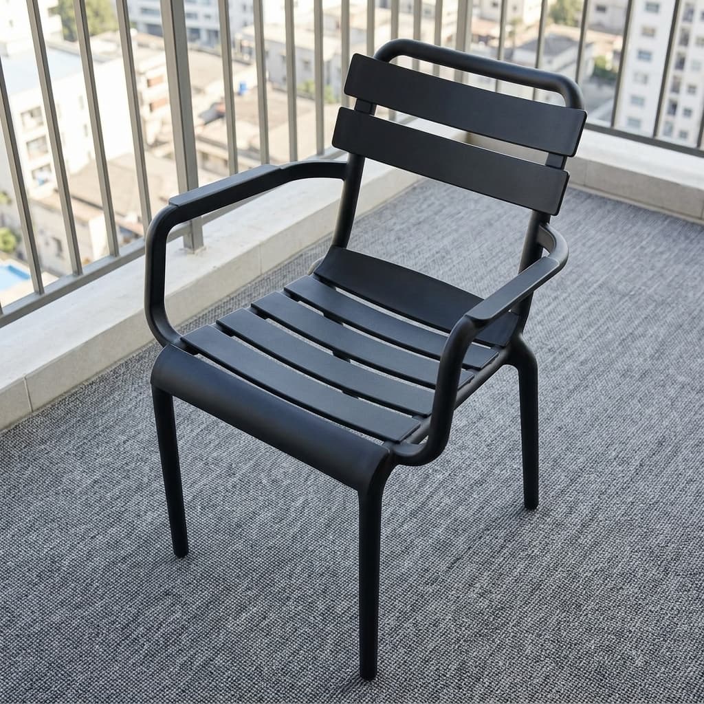 Stackable Plastic Dining Armchair Showcasing A Molded Black Polypropylene Frame, A Curved Slatted Backrest And Seat Pan With Horizontal Planks, And Integrated Loop Armrests.