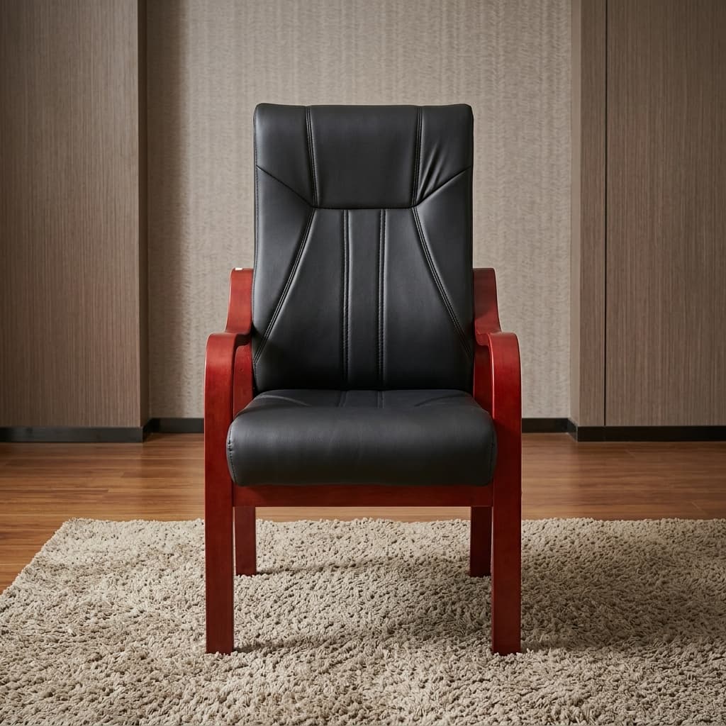 Luxury Executive Visitor Chair With Smooth Black Upholstery, A Tall Padded Backrest, Vertical Stitched Detailing, Broad Cushioned Seat, Curved Reddish-Brown Wooden Armrests And Four Fixed Wooden Legs.