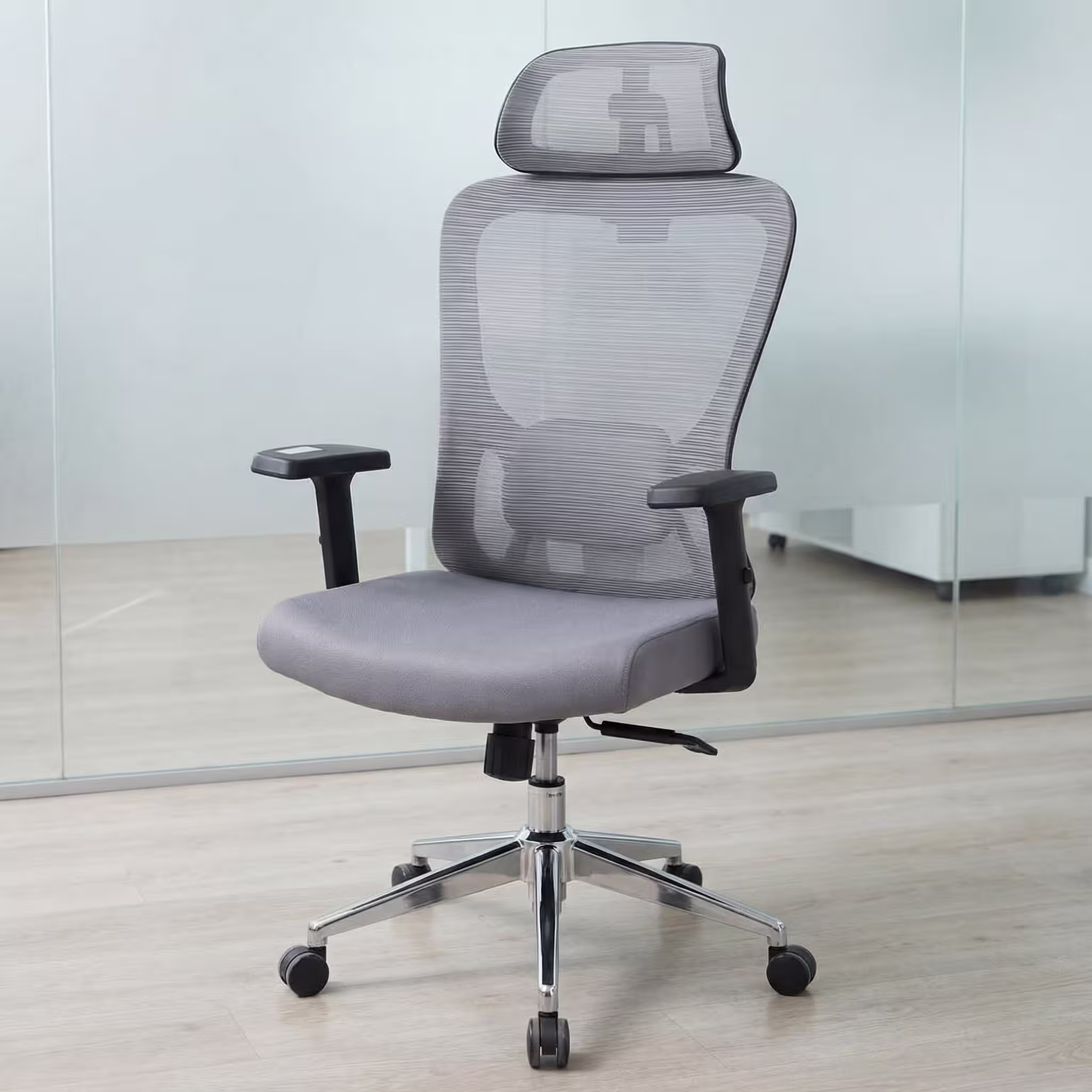 Ergonomic Mesh Office Chair with adjustable headrest, lumbar support, reclining function, and swivel base in a modern office setting