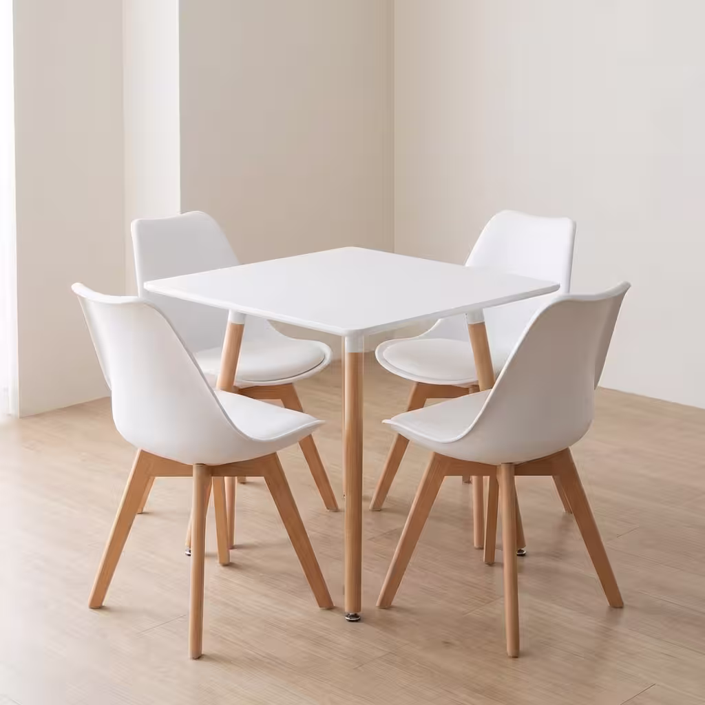 Modern 4-Seater Dining Set With White Table And Molded Chairs Featuring Solid Wooden Legs In A Contemporary Dining Space
