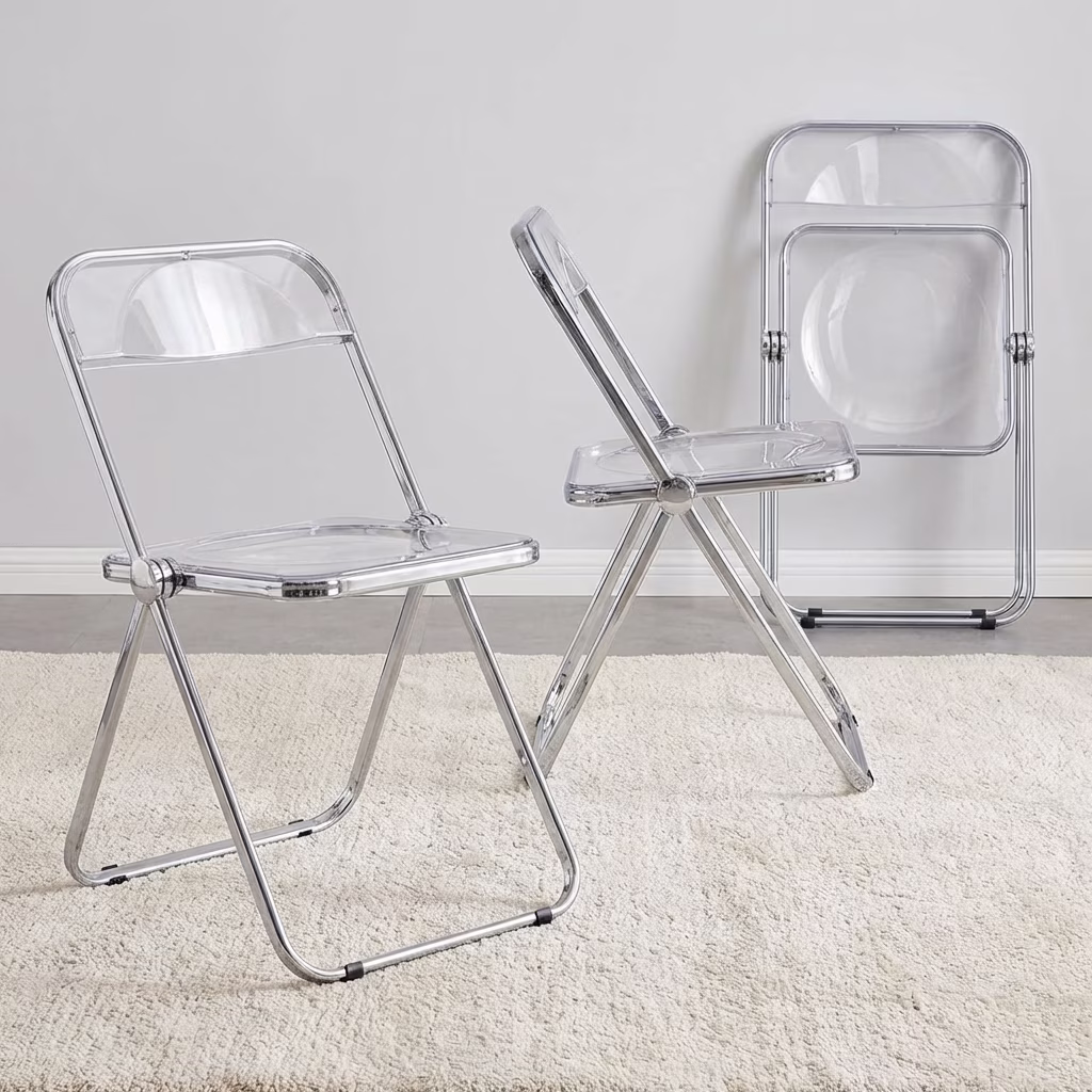A Clear Acrylic Folding Chair Featuring A Transparent Plastic Seat And Backrest With A Shiny Polished Chrome Metal Folding Frame.