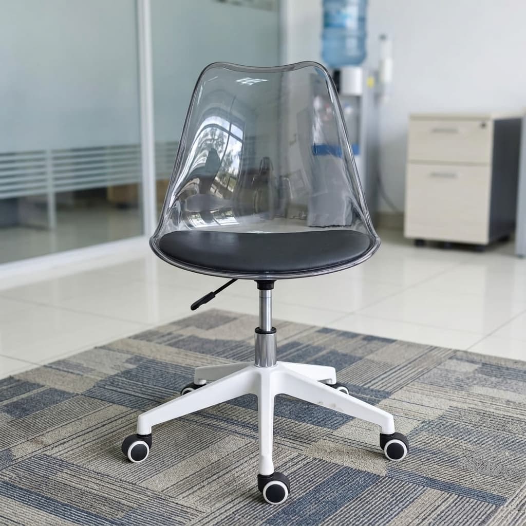A Transparent Clear Acrylic Swivel Desk Chair Featuring A Molded See-Through Shell, A Black Padded Seat Cushion, An Adjustment Lever, And A White Five-Star Wheeled Base.