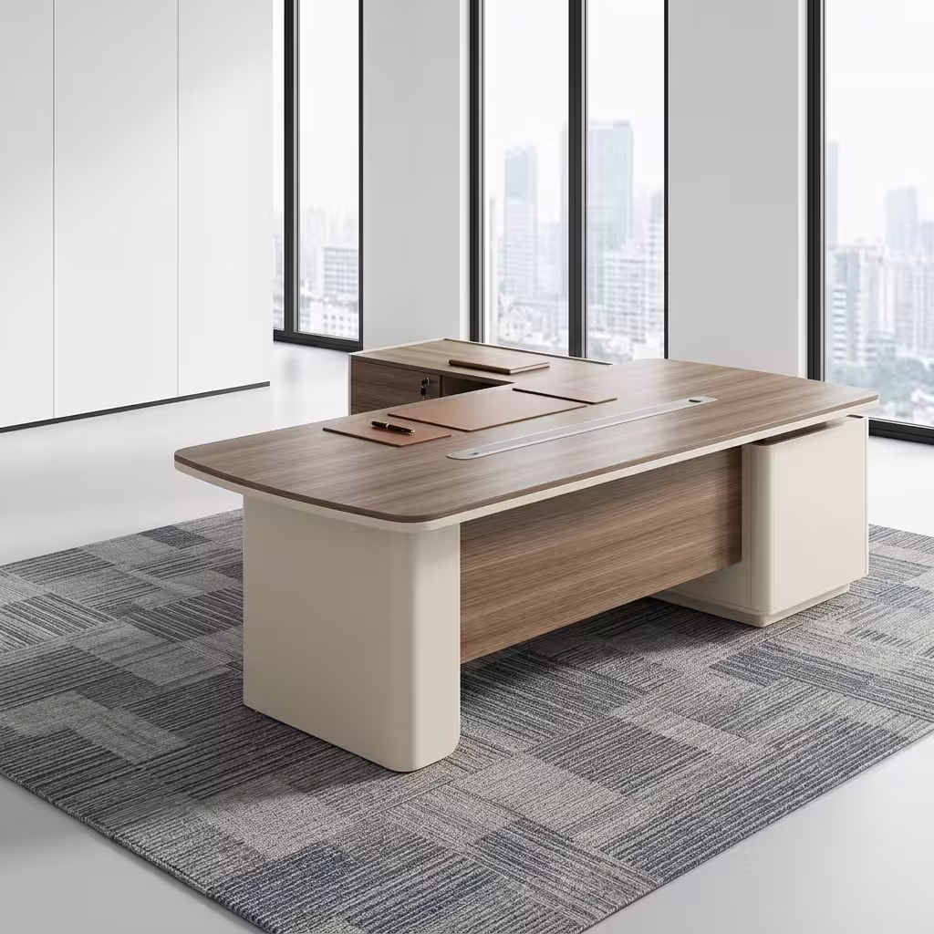 An L-Shaped 2.4M Modern Ceo Desk Featuring A Light Brown Wood Top With Rounded Corners, A Long Silver Cable Management Strip, And Smooth Cream-Colored Base Legs With A Matching Locking Side Return Unit.