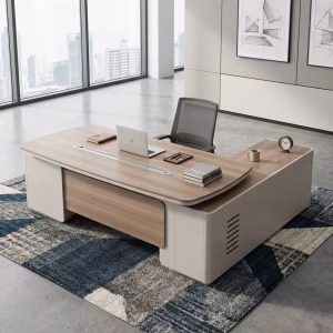 An L-shaped 2.4m Modern CEO Desk featuring a light brown wood top with rounded corners, a long silver cable management strip, and smooth cream-colored base legs with a matching locking side return unit.
