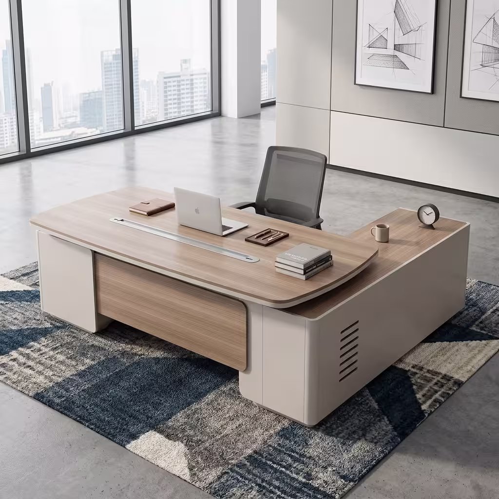 An L-Shaped 2.4M Modern Ceo Desk Featuring A Light Brown Wood Top With Rounded Corners, A Long Silver Cable Management Strip, And Smooth Cream-Colored Base Legs With A Matching Locking Side Return Unit.