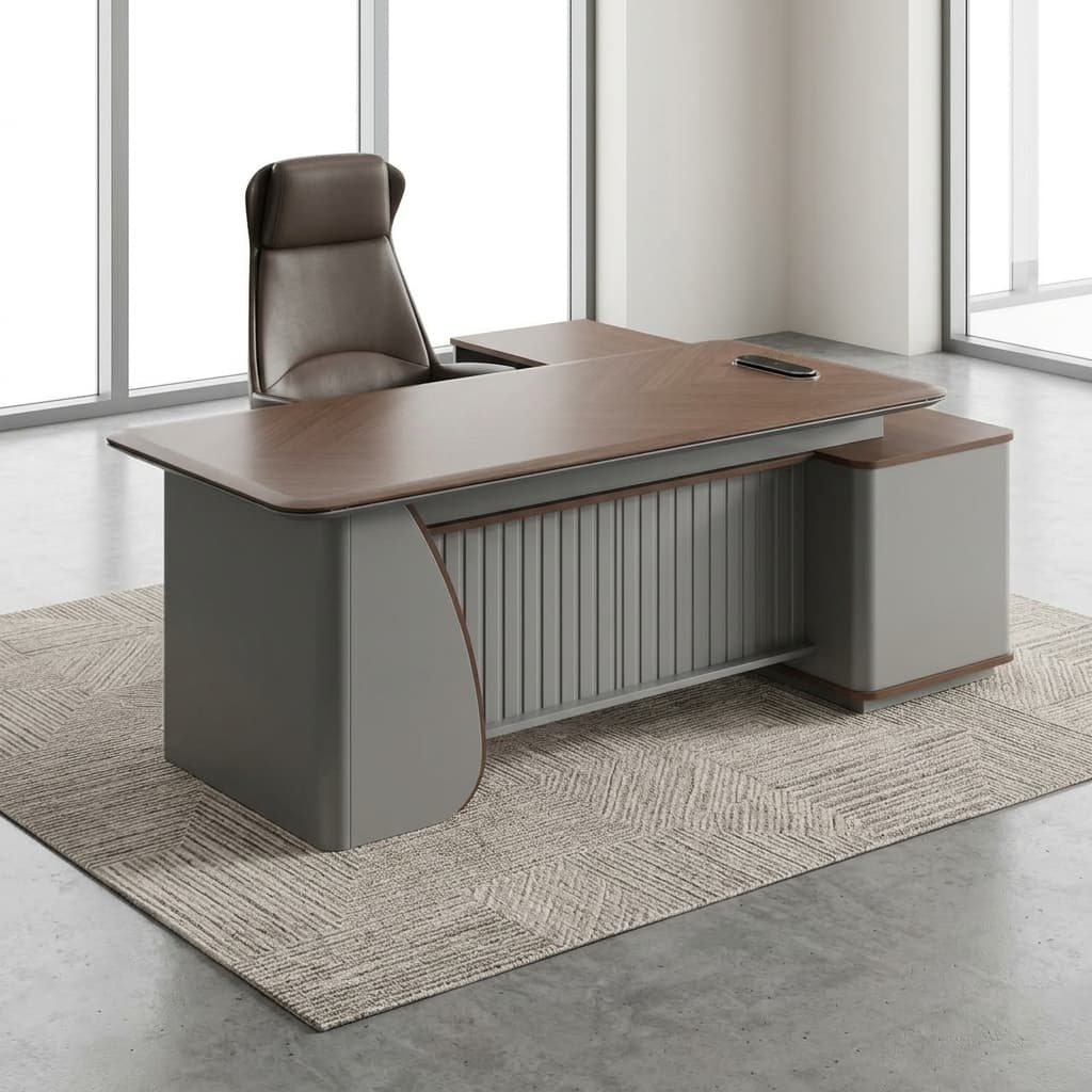 2.2M Office Workstation Desk Featuring A Chevron-Patterned Walnut Woodgrain Top, Silver-Gray Fluted Front Modesty Panel, And An Integrated Side Return Cabinet.