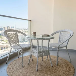 3-Piece Rattan Garden Furniture with two light grey and white woven chairs, curved armrests, open-pattern backrests and round glass-top table with lower shelf